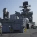 A U.S. Marines personnel gestures at the flight deck of the USS America (LHA 6) during a scheduled port visit in Manila, Philippines on Tuesday, March 21, 2023.