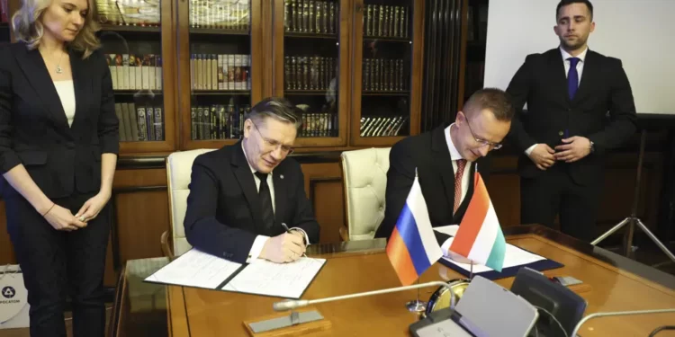 Hungary Signs New Energy Deal With Russia 1 In this handout photo released by Communications Department of Rosatom, Alexey Likhachev, Director General of State Atomiс Energy Corporation Rosatom, left, and Peter Szijjarto, Minister of Foreign Affairs and Trade of Hungary sign a document during their meeting in Moscow, Russia, Tuesday, April 11, 2023.