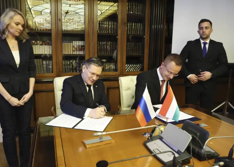 Hungary Signs New Energy Deal With Russia 1 In this handout photo released by Communications Department of Rosatom, Alexey Likhachev, Director General of State Atomiс Energy Corporation Rosatom, left, and Peter Szijjarto, Minister of Foreign Affairs and Trade of Hungary sign a document during their meeting in Moscow, Russia, Tuesday, April 11, 2023.