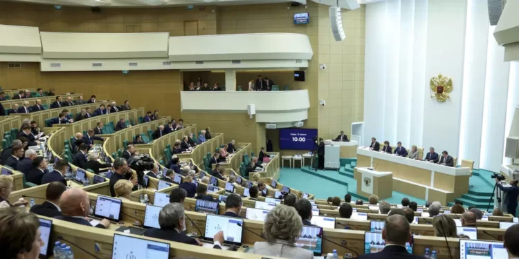 In this handout photo released by The Federal Assembly of The Russian Federation, members of the Federal Assembly of The Russian Federation attend a session in Moscow, Russia, Wednesday, April 12, 2023.