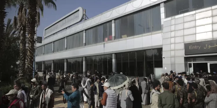 Yemeni gather at the airport ahead of a prisoners exchange in Sanaa, Yemen, Friday, April 14, 2023.