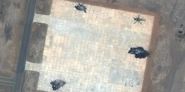 This satellite image provided by Maxar Technologies shows destroyed helicopters at a helicopter base in south Khartoum, Sudan.