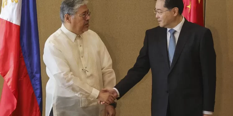 Chinese Foreign Minister Qin Gang, right, and Philippine Foreign Affairs Secretary Enrique Manalo shake hands during the welcome ceremony prior to their bilateral meeting at the Diamond Hotel on Saturday, April 22, 2023, in Manila, Philippines.