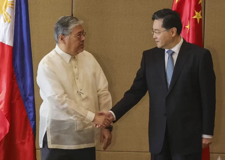 Chinese Foreign Minister Qin Gang, right, and Philippine Foreign Affairs Secretary Enrique Manalo shake hands during the welcome ceremony prior to their bilateral meeting at the Diamond Hotel on Saturday, April 22, 2023, in Manila, Philippines.