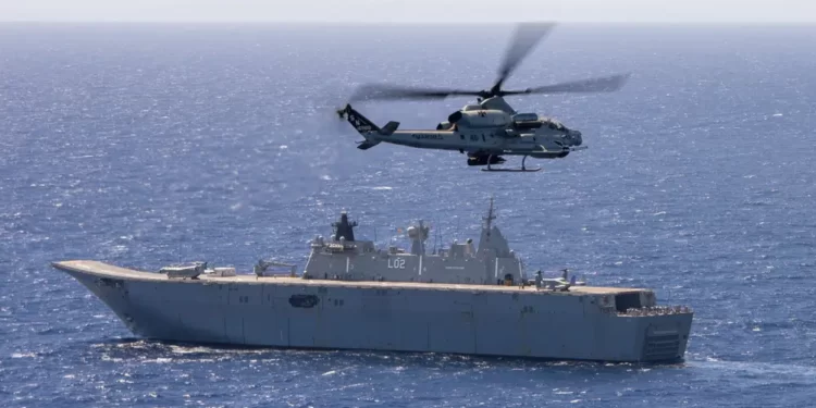 Australia Poised To Spend More Money On Defense 1 undated photo provided by the Australian Defense Force, an AH-1Z Viper, attached to Marine Light Attack Helicopter Squadron (HMLA) 169, conducts flight operations with Royal Australian Navy Canberra-class landing helicopter dock HMAS Canberra, during Exercise Rim of the Pacific 2022.
