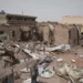 A man walks by a house hit in recent fighting in Khartoum, Sudan, Tuesday, April 25, 2023.