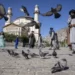 Afghan people walk pass the Shah-Do Shamshira Mosque during the first day of Eid al-Fitr in Kabul, Afghanistan, Friday, April 21, 2023.
