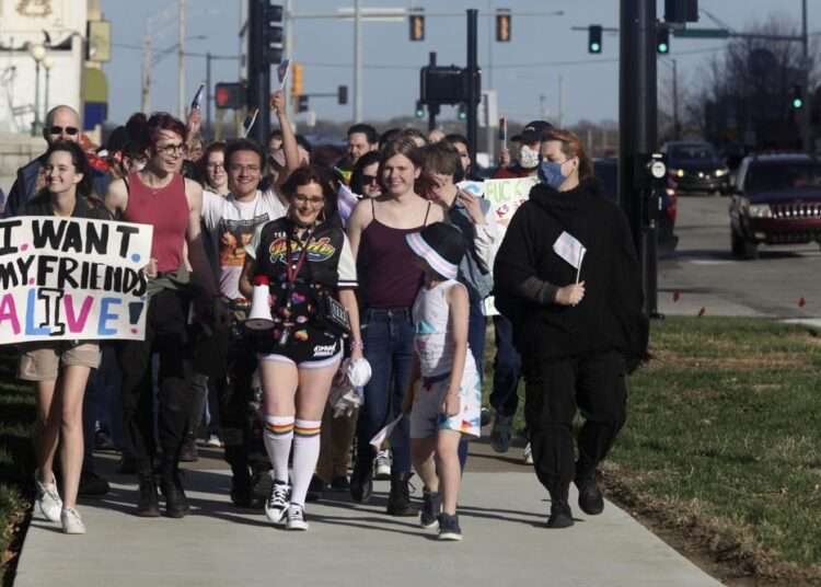 More than 100 people, many of them transgender youth, march around the Kansas Statehouse on the annual Transgender Day of Visibility, Friday, March 31, 2023, in Topeka, Kansas.