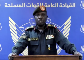In this frame grab from a video posted by Sudan's state news agency, SUNA on Thursday, April 13, 2023, spokesman for the Sudanese Armed Forces Brig. Nabil Abdullah reads a statement warning of conflict after the recent deployment of Sudan's powerful paramilitary in the capital and other cities.