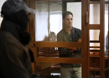 Wall Street Journal reporter Evan Gershkovich stands in a glass cage in a courtroom at the Moscow City Court, in Moscow, Russia, Tuesday, April 18, 2023.