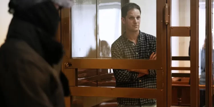 Wall Street Journal reporter Evan Gershkovich stands in a glass cage in a courtroom at the Moscow City Court, in Moscow, Russia, Tuesday, April 18, 2023.