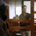 Wall Street Journal reporter Evan Gershkovich stands in a glass cage in a courtroom at the Moscow City Court, in Moscow, Russia, Tuesday, April 18, 2023.