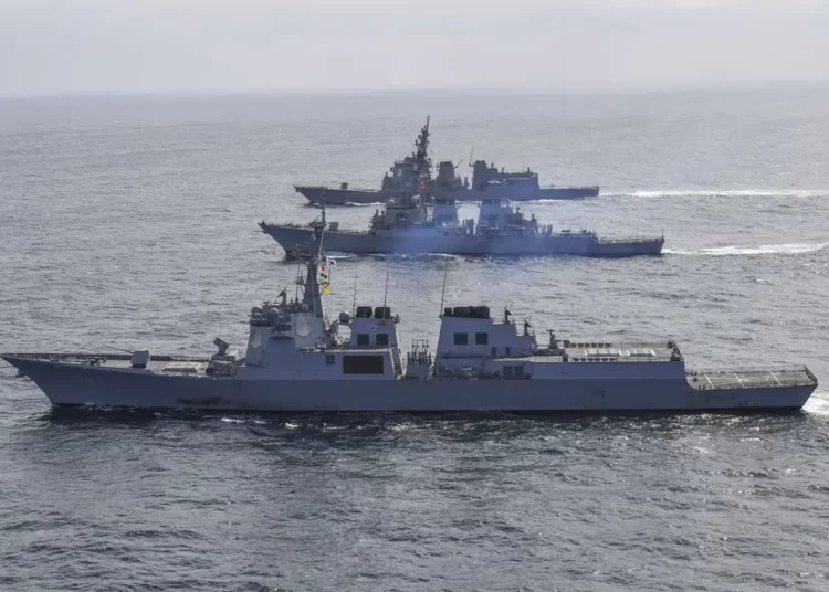 In this photo provided by South Korea Defense Ministry, South Korean Navy's destroyer Yulgok Yi I, bottom, U.S. Navy's the guided missile destroyer USS Benfold and Japan Maritime Self-Defense Force's destroyer Atago, top, sail during a joint missile defense drill among South Korea, the United States and Japan in the international waters of the east coast of Korean peninsular, Monday, April 17, 2023.