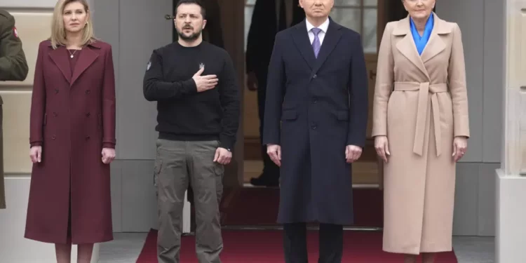 Poland's President Andrzej Duda, 2nd right, with his wife Agata Kornhauser-Duda welcomes Ukrainian President Volodymyr Zelenskyy with his wife Olena, left, as they meet at the Presidential Palace in Warsaw, Poland, Wednesday, April 5, 2023.