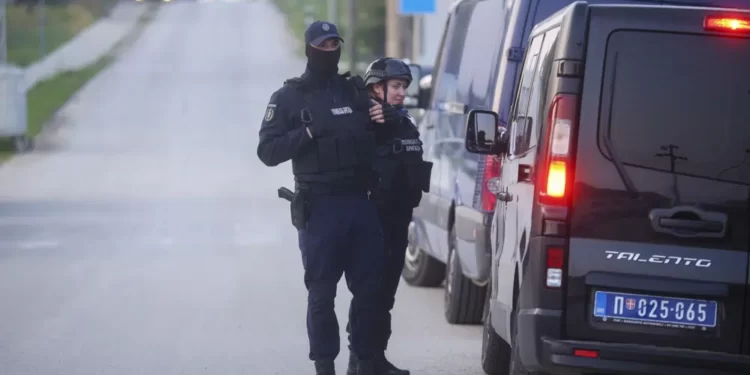 Second Mass Shooting In Serbia Leaves Eight People Dead 1 Police officers stand guard on a road in the village of Dubona, some 50 kilometers (30 miles) south of Belgrade, Serbia, Friday, May 5, 2023, as they block the road near the scene of a Thursday night attack.