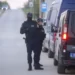 Police officers stand guard on a road in the village of Dubona, some 50 kilometers (30 miles) south of Belgrade, Serbia, Friday, May 5, 2023, as they block the road near the scene of a Thursday night attack.