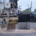 Workers load grain at a grain port in Izmail, Ukraine, on April 26, 2023.