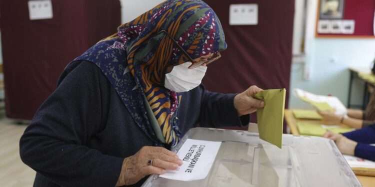 A woman votes at a polling station in Ankara, Turkey, Sunday, May 14, 2023.