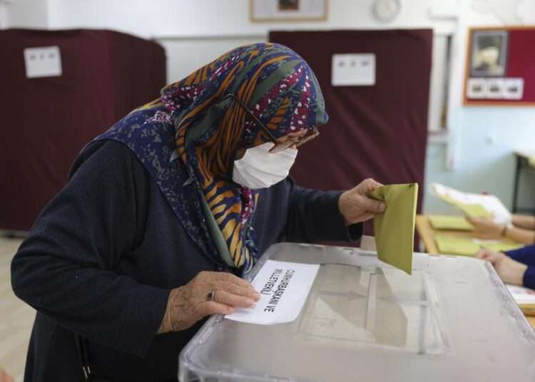 A woman votes at a polling station in Ankara, Turkey, Sunday, May 14, 2023.