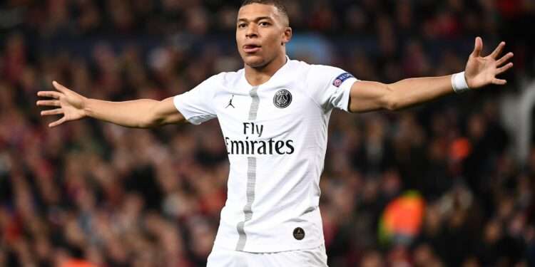 Paris Saint-Germain's French striker Kylian Mbappe celebrates scoring his team's second goal during the first leg of the UEFA Champions League round of 16 football match between Manchester United and Paris Saint-Germain (PSG) at Old Trafford in Manchester, north-west England on February 12, 2019. (Photo by FRANCK FIFE / AFP)        (Photo credit should read FRANCK FIFE/AFP via Getty Images)