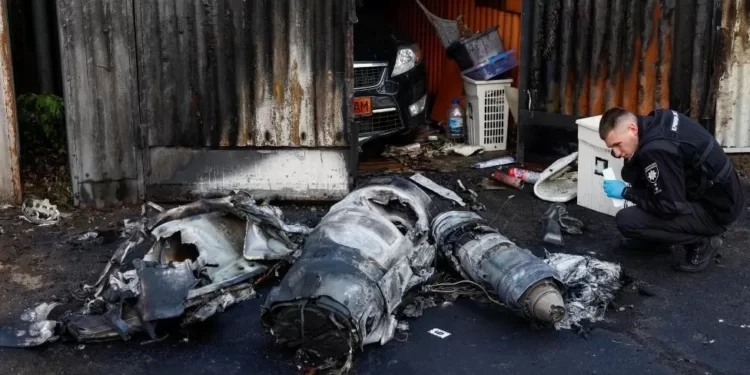 A police officer inspects the remains of a Russian missile shot down by Ukrainian air defense.