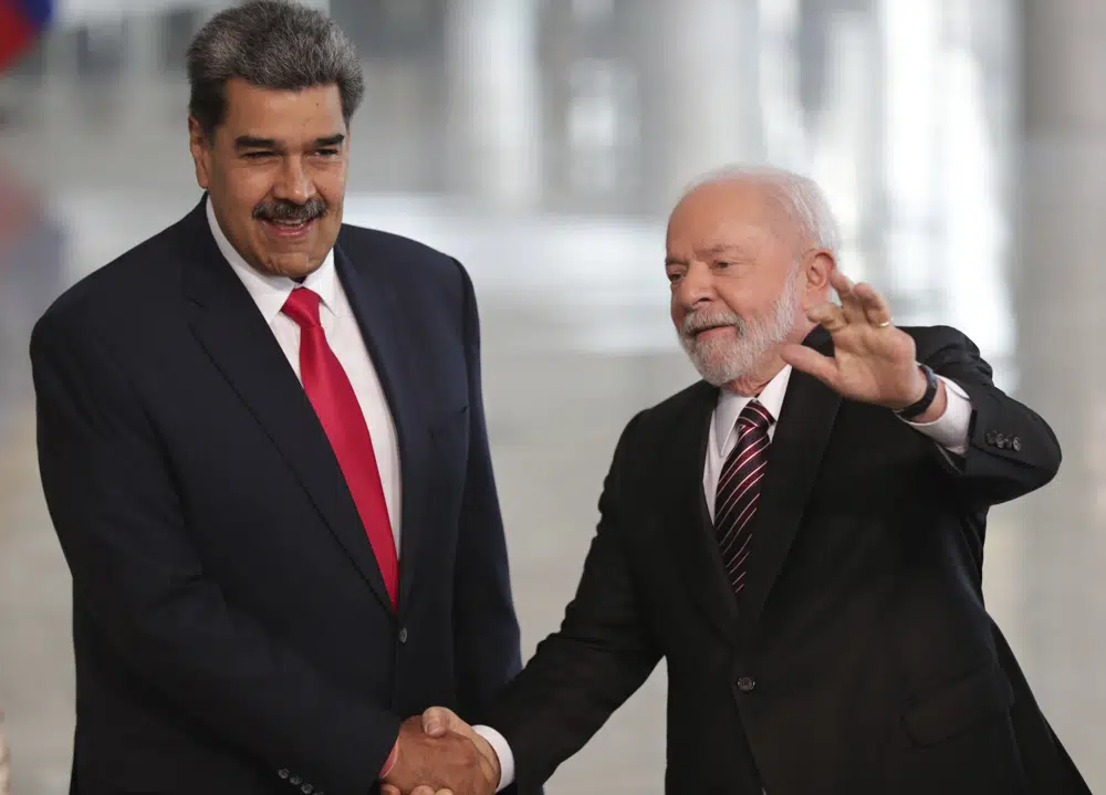 Brazilian President Luiz Inacio Lula da Silva right shakes hands with Venezuelas President Nicolas Maduro