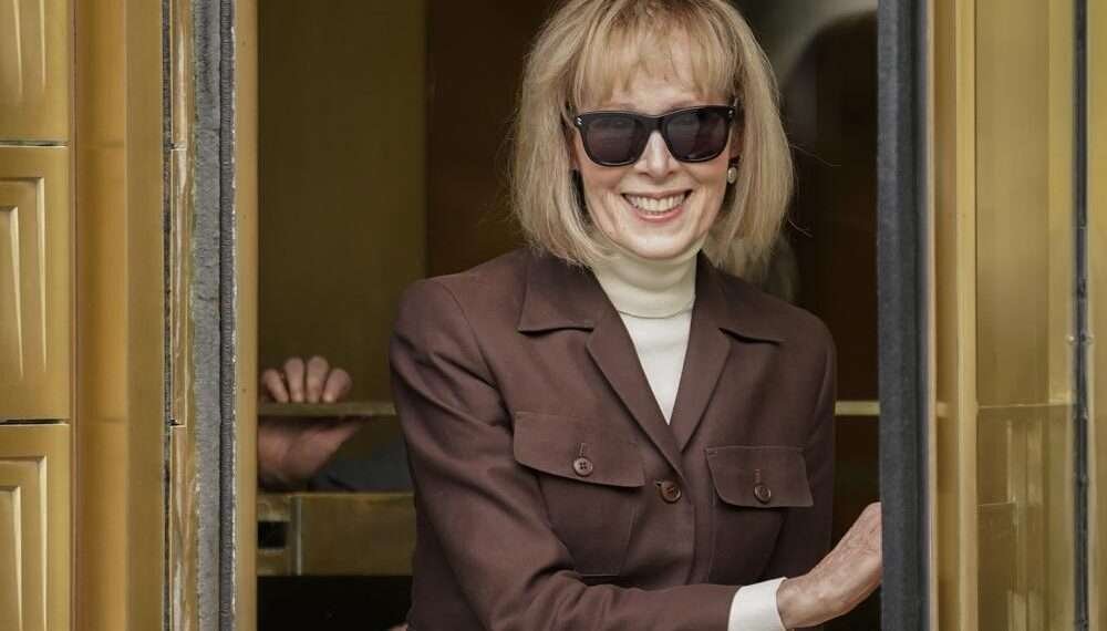 E. Jean Carroll, center, walks out of Manhattan federal court.