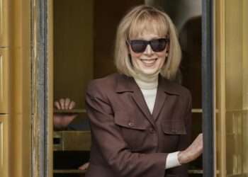 E. Jean Carroll, center, walks out of Manhattan federal court.
