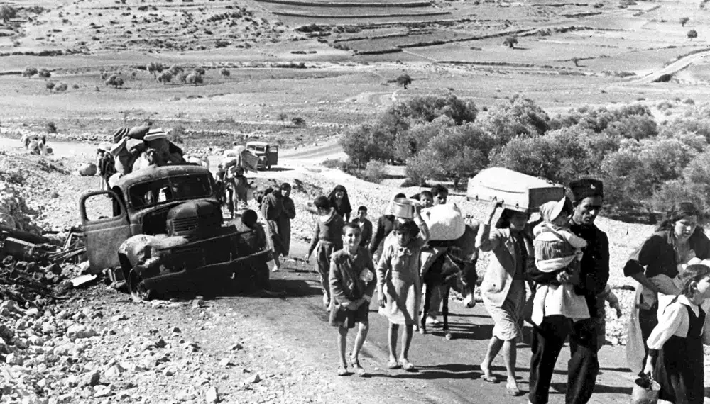 UN To Officially Recognize 1948 Palestinians Exodus From Israel 1 A group of Arab refugees walks along a road from Jerusalem to Lebanon, carrying their belongings with them on Nov. 9, 1948. The group was driven from their ho.mes by attacks in Galilee