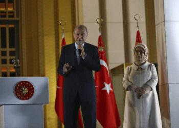 Turkish President and People's Alliance's presidential candidate Recep Tayyip Erdogan, left, makes a speech next to his wife, Emine, at the presidential palace, in Ankara, Turkey, Sunday, May 28, 2023.