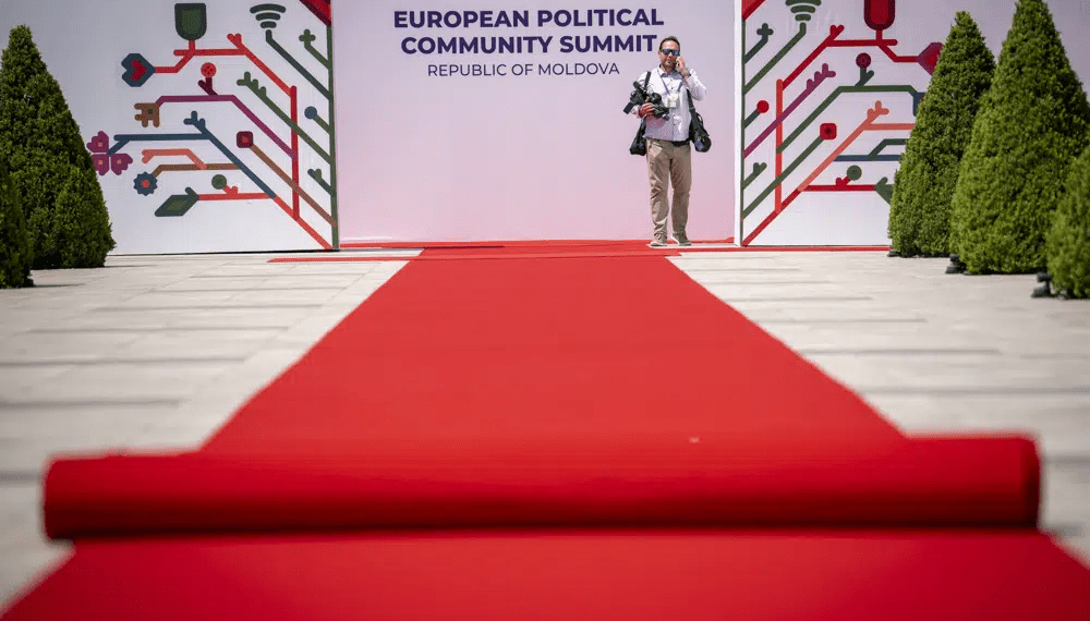 A man stands by banners during preparations at the Castel Mimi in Bulboaca, Moldova, Wednesday, May 31, 2023.