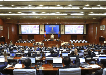 In this photo released by De Ratha/Cambodia National Assembly, Cambodian lawmaker raise their hands to approve amending the country’s election law at the National Assembly, in Phnom Penh, Cambodia, Friday, June 23, 2023.