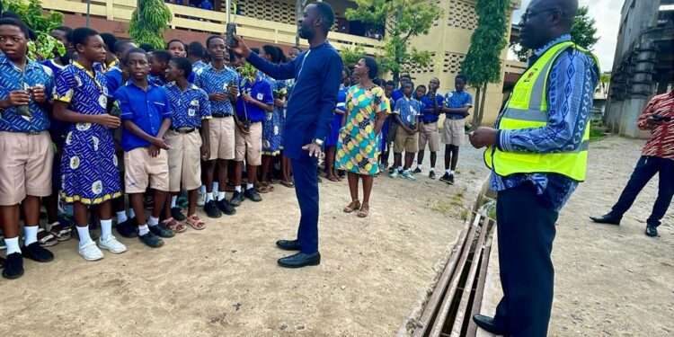 Green Ghana Day 2023: ECG Cautions Individuals From Planting Trees Beneath Low-Voltage Lines 1 ECG officials with students on Green Ghana Day
