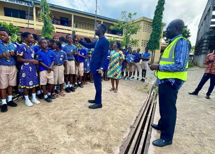 ECG officials with students on Green Ghana Day