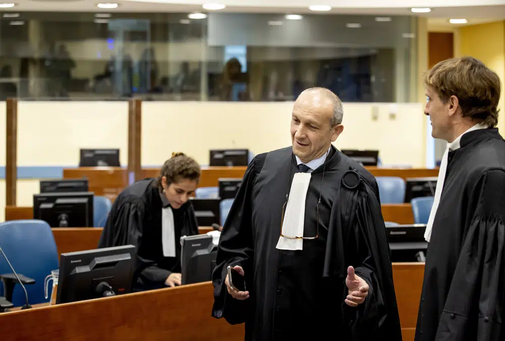 Felicien Kabugas defense lawyer Emmanuel Altit left speaks with prosecutor Rupert Elderkin in court at the UN International Residual Mechanism for Criminal Tribunals IRMCT in The Hague