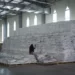 A worker walks next to a pile of sacks of food earmarked for the Tigray and Afar regions in a warehouse of the World Food Programme (WFP) in Semera, the regional capital for the Afar region, in Ethiopia.