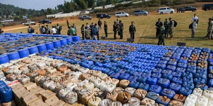 UN Warns of Methamphetamine Trade In Asia 1 Foreign military attachÈs check drugs in a football ground where seized drugs, vehicles, laboratory accessories and precursor chemicals are being displayed to be witnessed by invited military attachÈs and journalists in Kawnghka at Shan State on March 6, 2020. - 97 million US dollar worth of drugs and related items were seized this year during a special operation held to crack down drugs trafficking, a military spokesperson said. (Photo by YE AUNG THU / AFP)