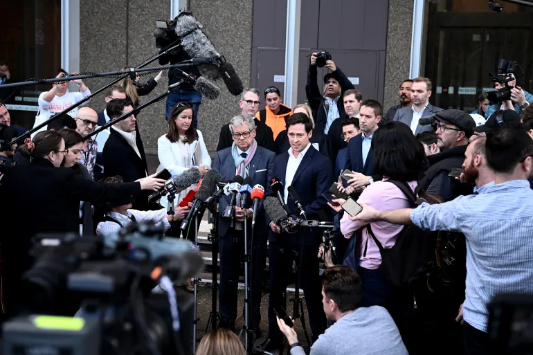 Journalists Nick McKenzie and Chris Masters who reported on the soldiers alleged war crimes give a statement outside the Federal Court 1