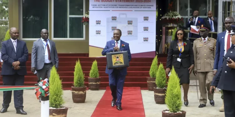 Kenya's Minister of Finance Njuguna Ndung'u holds a briefcase containing the government budget for upcoming fiscal year, at the Treasury headquarters in downtown Nairobi, Kenya.