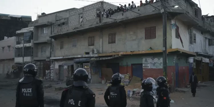 Police Clash With Demonstrators, Leave 15 Dead In Senegal 1 Police in riot gear stand guard during clashes with demonstrators in Dakar, Senegal.