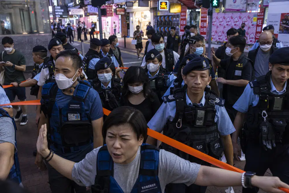 Police officers take away a member of the public in the Causeway Bay area on the eve of the 34th anniversary of Chinas Tiananmen Square massacre in Hong Kong