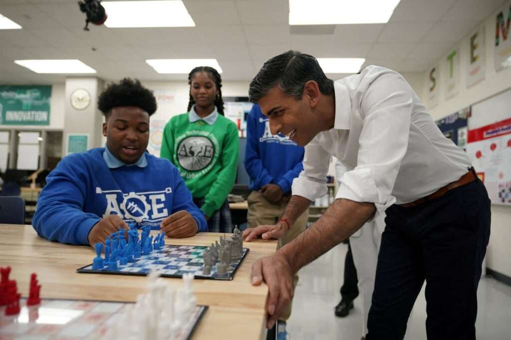 Prime Minister Rishi Sunak is shown a 3D printed chess set during a visit to the Friendship Technology Preparatory High School in Washington