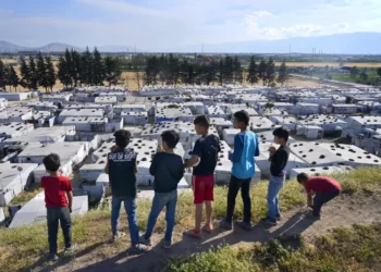 Syrian children stand on a hill above a refugee camp in the town of Bar Elias, in Lebanon's Bekaa Valley.