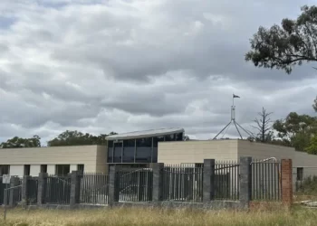 The Australian flag flies on Parliament House, seen behind an unoccupied building on the grounds of a proposed new Russian embassy near the Australian Parliament in Canberra.