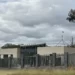 The Australian flag flies on Parliament House, seen behind an unoccupied building on the grounds of a proposed new Russian embassy near the Australian Parliament in Canberra.