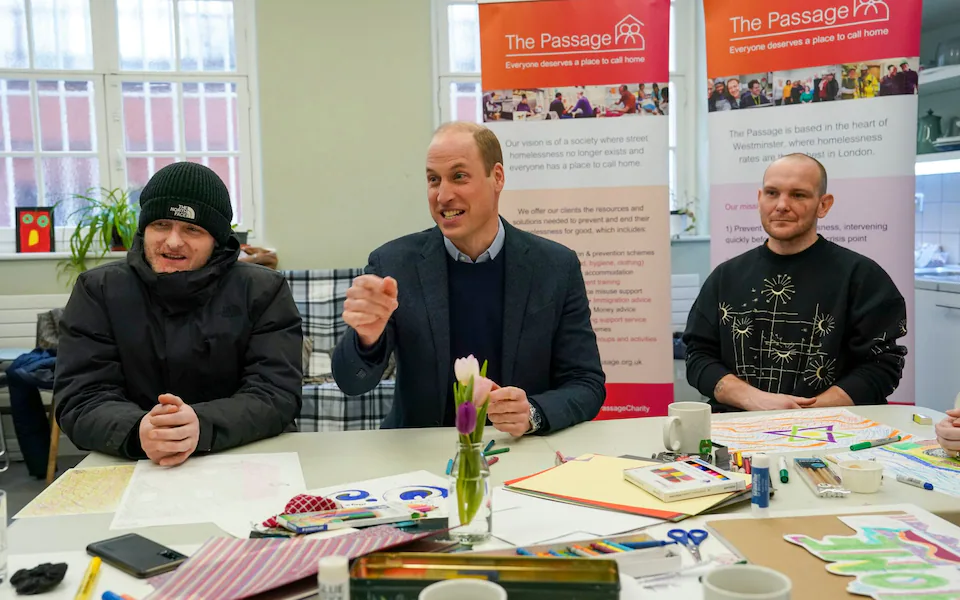 The Prince of Wales with residents during a visit to the London homelessness charity