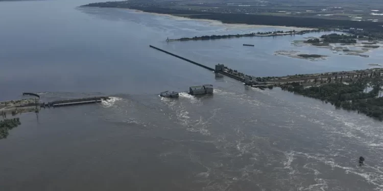 Water flows over the collapsed Kakhovka Dam in Nova Kakhovka, in Russian-occupied Ukraine.