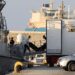 “Floating Coffins”: Meeting Death While Seeking A Future Of Hope 11 Rescue workers carry bodies from a coast guard vessel to a refrigerated truck at the port in Kalamata town.