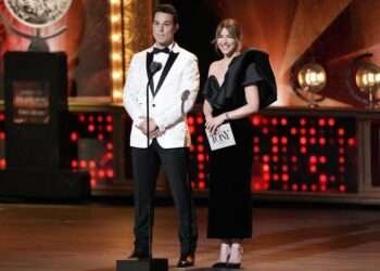 Hosts Skylar Astin, left, and Julianne Hough speak on stage at the 76th annual Tony Awards