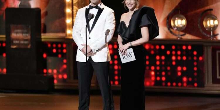 Hosts Skylar Astin, left, and Julianne Hough speak on stage at the 76th annual Tony Awards